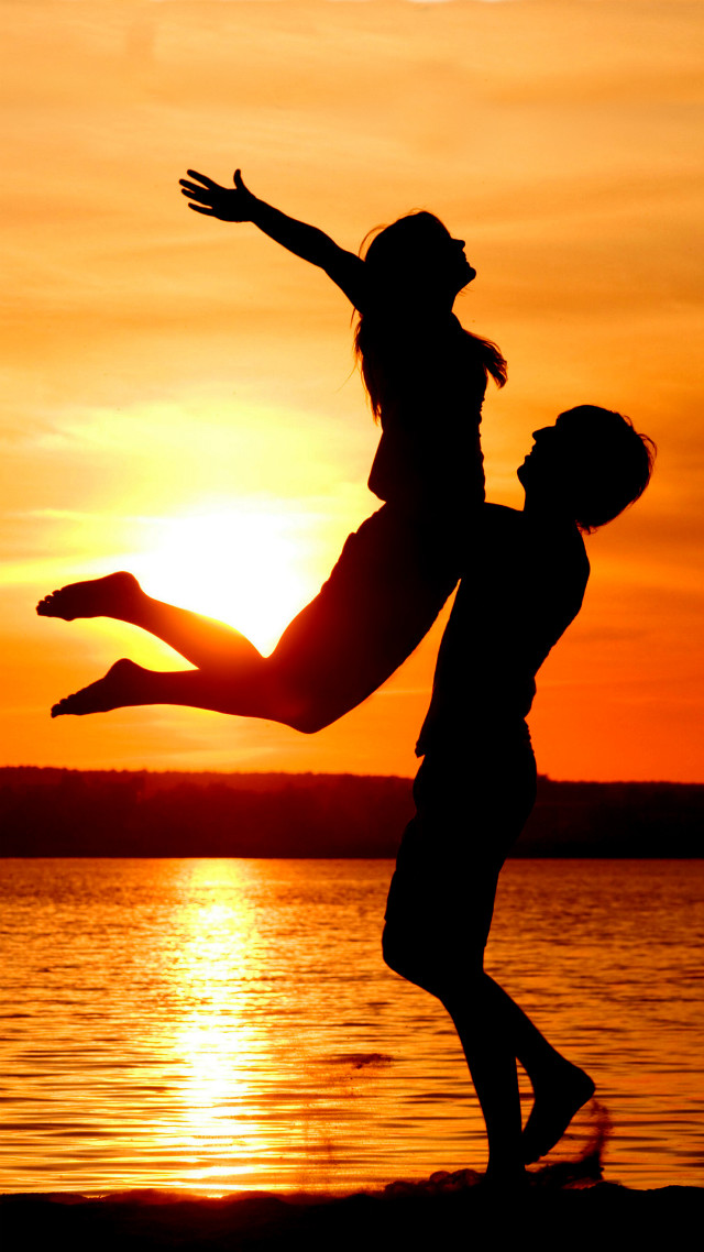 Man woman jumping sunset water free wallpaper for mobile - medium preview image