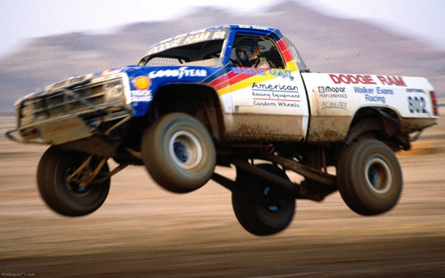 Truck jumping mountain sky background free wallpaper for desktop - medium preview image