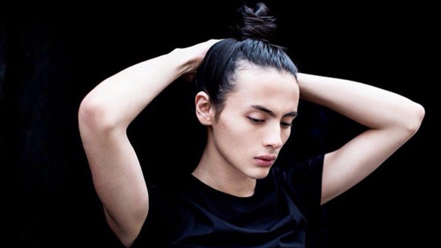 Woman messy topknot holding head free wallpaper for desktop - medium preview image