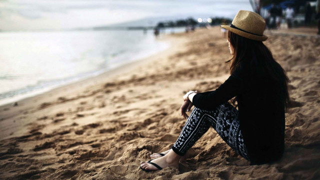 Woman sitting beach legs crossed free wallpaper for desktop - medium preview image