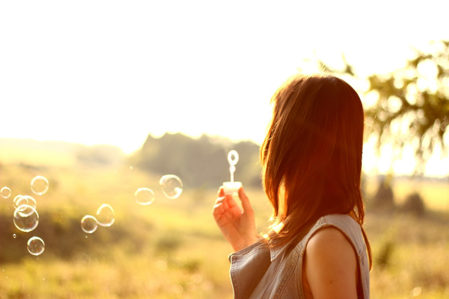Woman blowing bubbles tree field free wallpaper for desktop - medium preview image