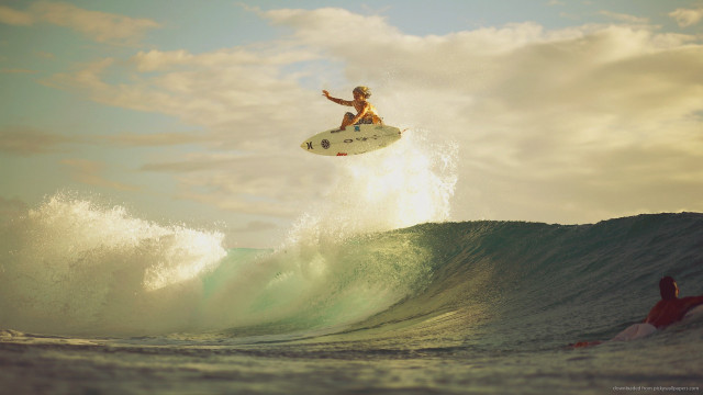 Man riding wave surfboard air free wallpaper for desktop - medium preview image