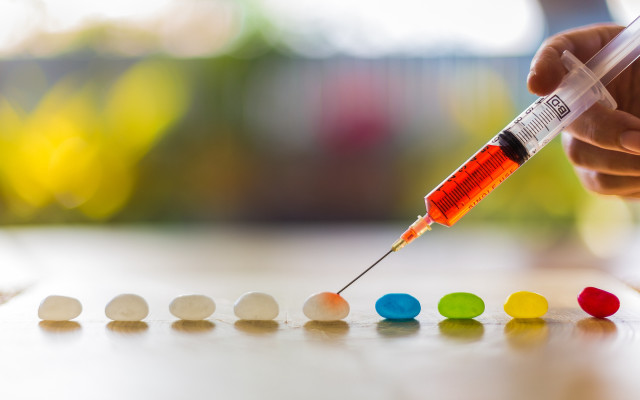 Person holding syil colored pills free wallpaper for desktop - medium preview image