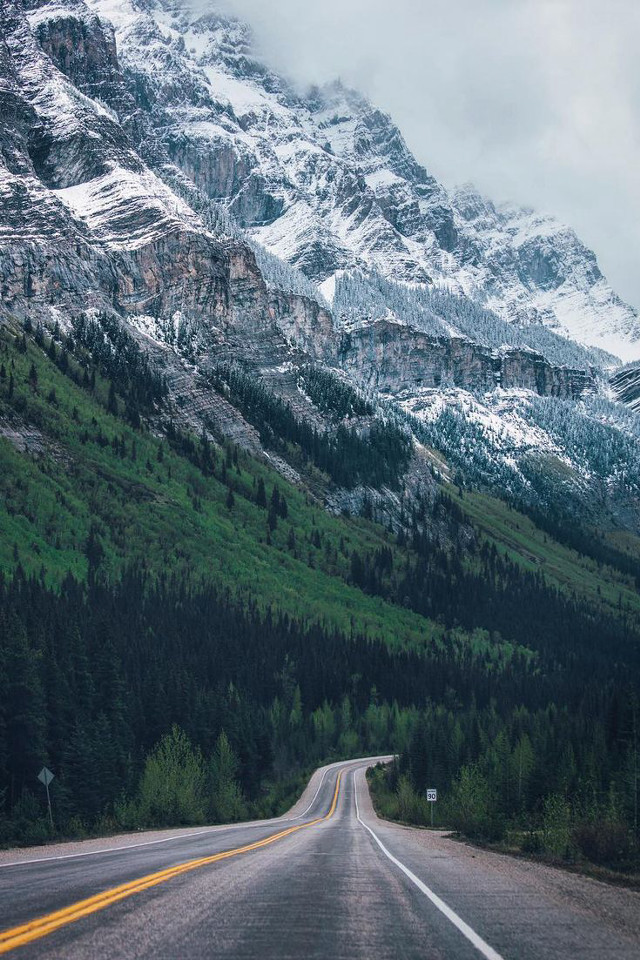 Mountain road yellowline cloudy sky free wallpaper for mobile - medium preview image