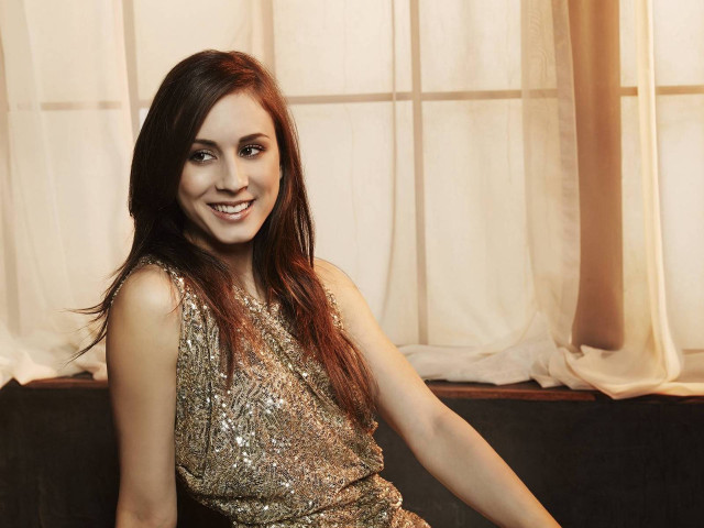 Woman gold dress couch smiling free wallpaper for desktop - medium preview image