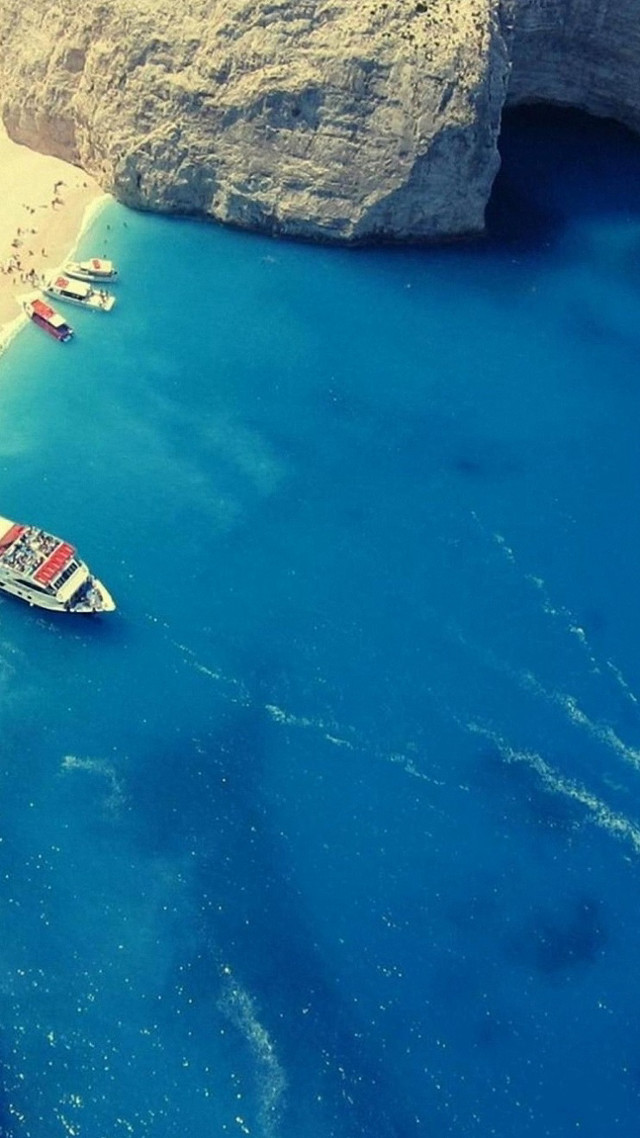 Boat water beach rock formation free wallpaper for mobile - medium preview image