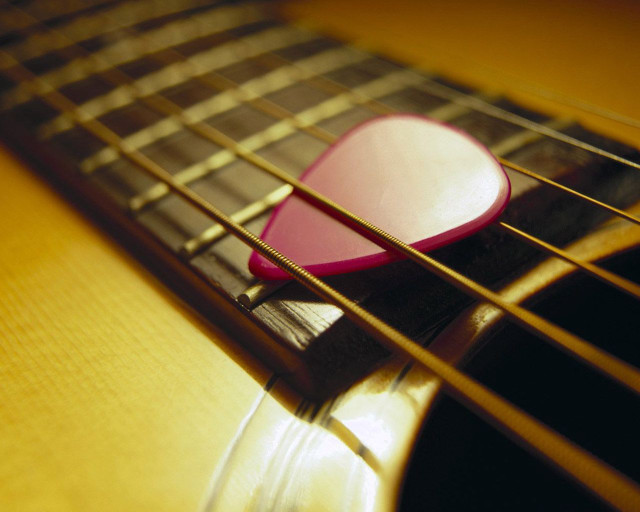 Guitar pick on guitar strings free wallpaper for desktop - medium preview image