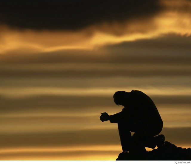 Silhouette man sitting rock sunset free wallpaper for desktop - medium preview image