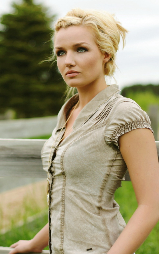 Woman standing fence field grass free wallpaper for mobile - medium preview image