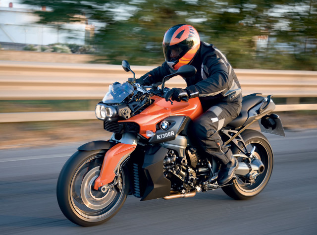 Motorcycle rider fence trees blurry free wallpaper for desktop - medium preview image