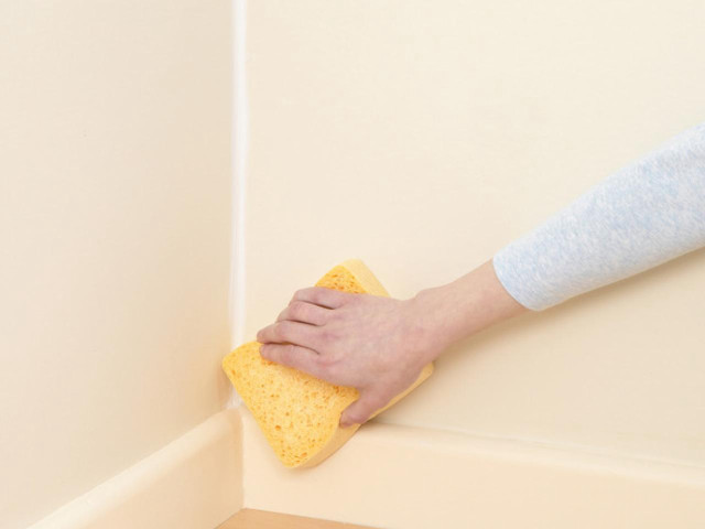 Person cleaning corner wall sponge free wallpaper for desktop - medium preview image