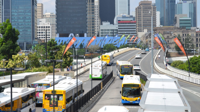 Buses driving street tall buildings free wallpaper for desktop - medium preview image