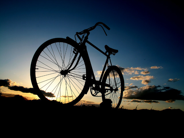 Bike parked grass sunset sun free wallpaper for desktop - medium preview image