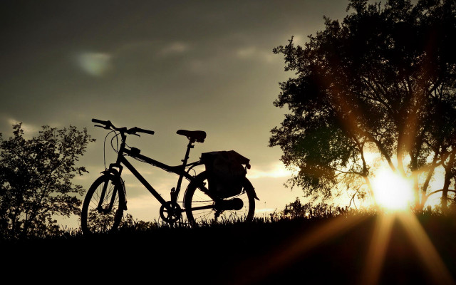 Bike parked hill sunset trees free wallpaper for desktop - medium preview image
