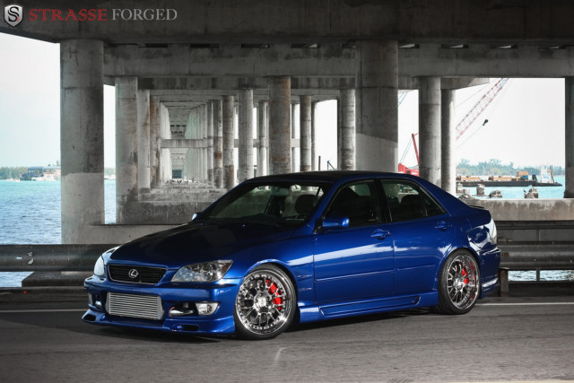 Blue car parked bridge water free wallpaper for desktop - medium preview image