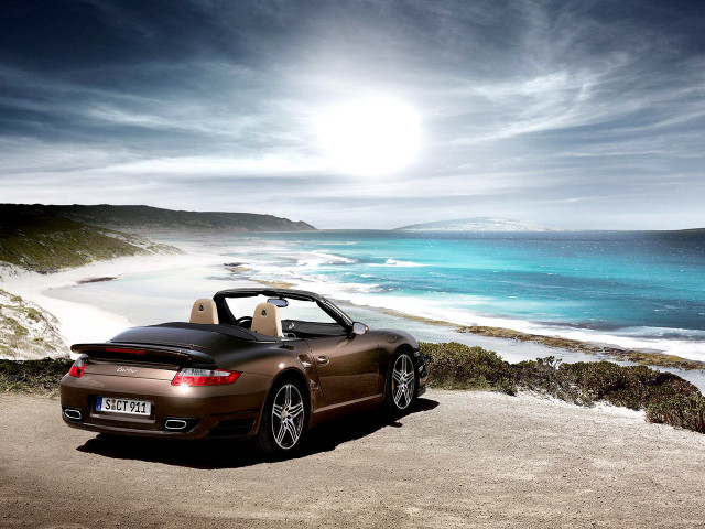 Brown sports car ocean beach free wallpaper for desktop - medium preview image