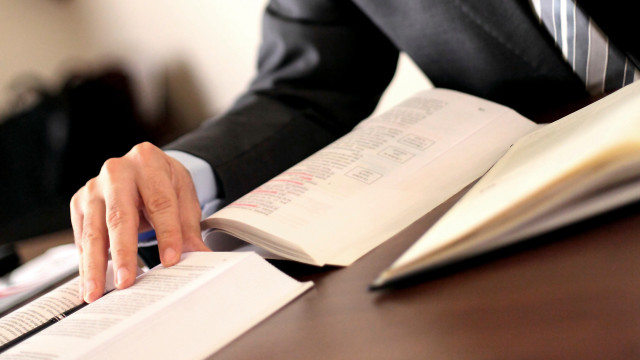 Man suit reading book desk free wallpaper for desktop - medium preview image