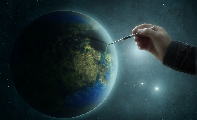 Hand holding paintbrush painting earth free wallpaper for desktop - medium preview image