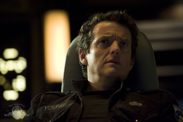 Man sitting serious look chair free wallpaper for desktop - medium preview image