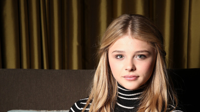 Woman sitting couch suitcase curtain free wallpaper for desktop - medium preview image