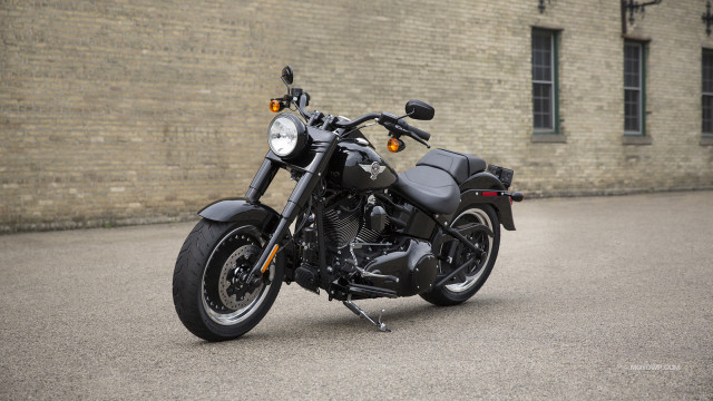 Motorcycle parked brick building wall free wallpaper for desktop - medium preview image