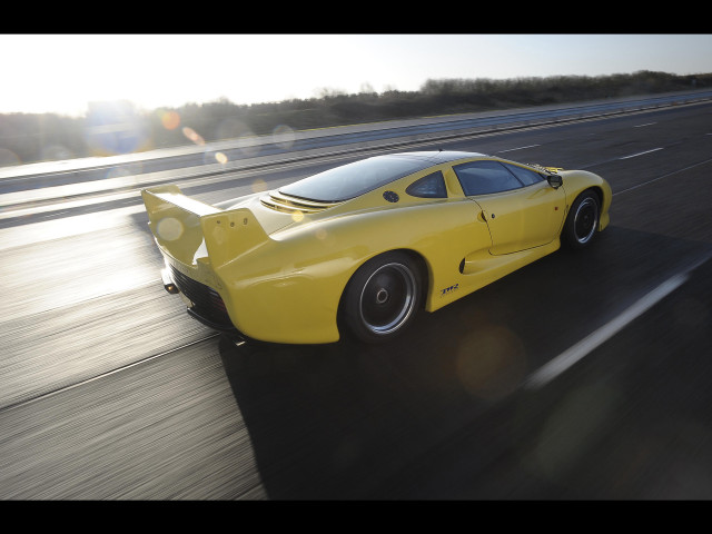Yellow sports car highway forest free wallpaper for desktop - medium preview image