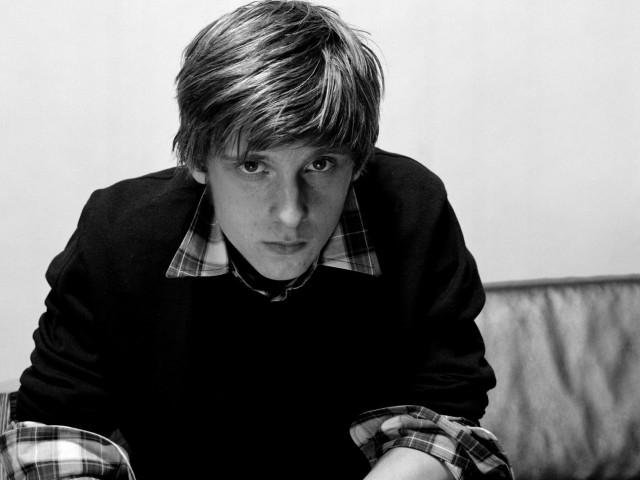 Young man couch serious look free wallpaper for desktop - medium preview image