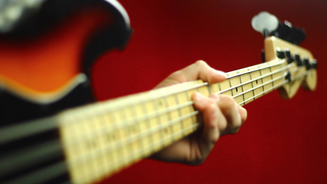 Person playing guitar red background free wallpaper for desktop - medium preview image