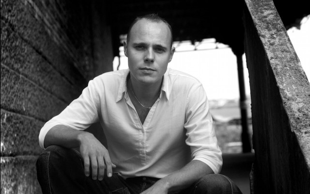 Man sitting ledged building hands free wallpaper for desktop - medium preview image