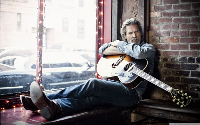 Man sitting window sill holding free wallpaper for desktop - medium preview image