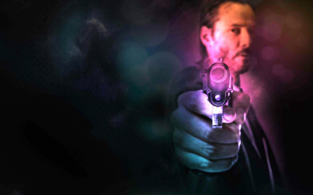 Man holding gun blurry background #2 free wallpaper for desktop - medium preview image