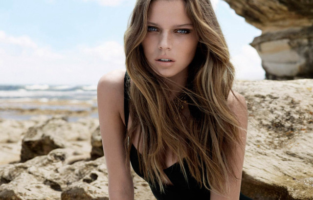 Woman black dress sitting rock free wallpaper for desktop - medium preview image