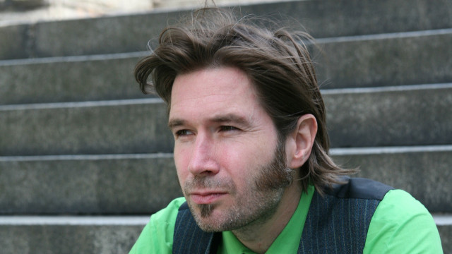 Man beard green shirt stairs free wallpaper for desktop - medium preview image