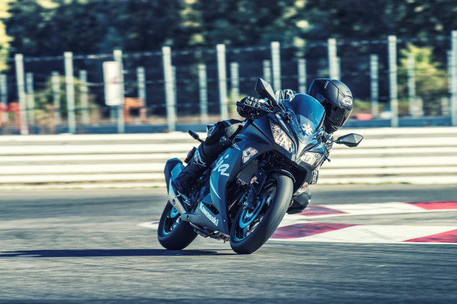 Person riding motorcycle race track free wallpaper for desktop - medium preview image