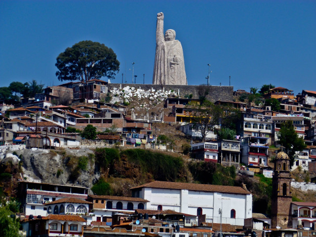 Large statue person hill buildings free wallpaper for desktop - medium preview image
