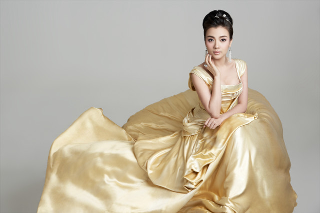 Woman golden dress posing hand free wallpaper for desktop - medium preview image