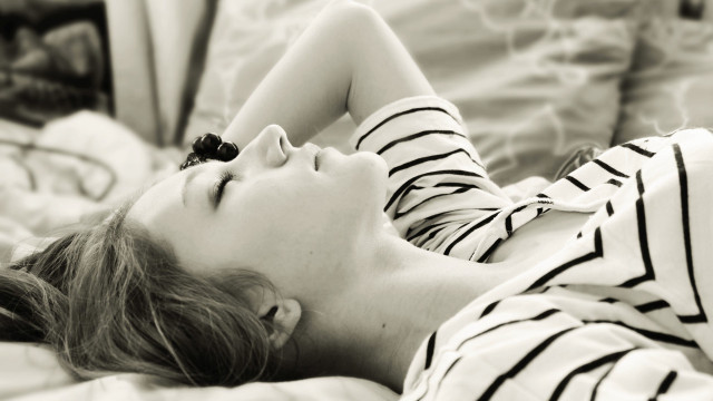 Woman laying bed eyes closed #3 free wallpaper for desktop - medium preview image