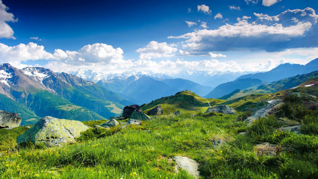 Grassy field mountains clouds sky free wallpaper for desktop - medium preview image
