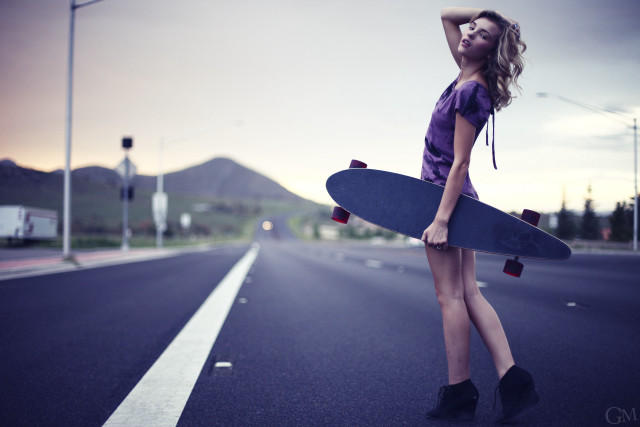 Woman holding skateboard side road free wallpaper for desktop - medium preview image