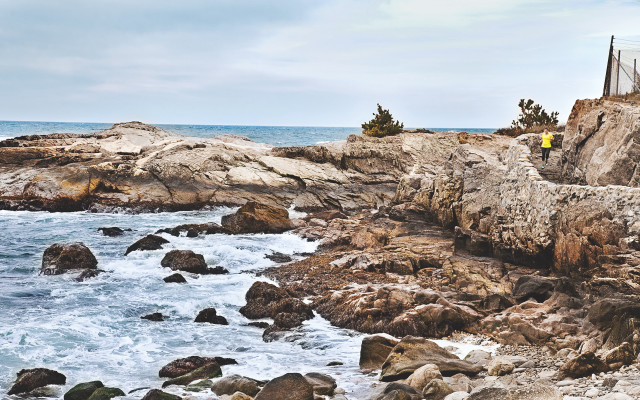 Man standing rocky cliff ocean free wallpaper for desktop - medium preview image