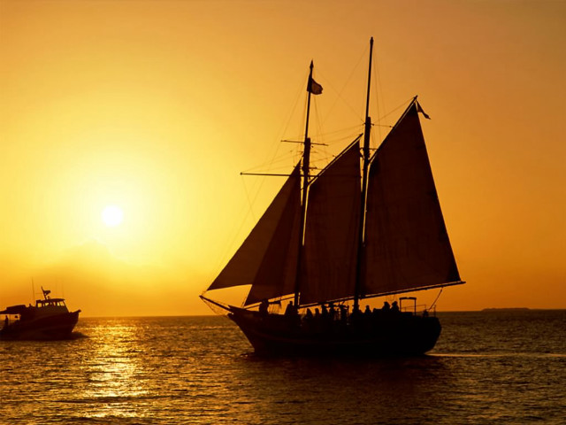 Sailboat ocean sunset foreground background free wallpaper for desktop - medium preview image
