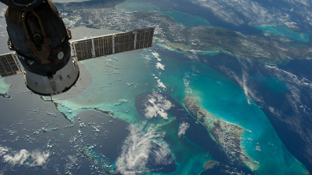 Satellite flying over water landforms free wallpaper for desktop - medium preview image