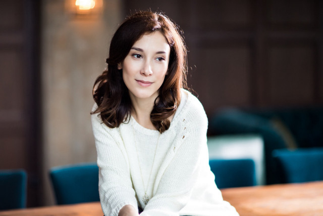 Woman sitting white sweater blue free wallpaper for desktop - medium preview image