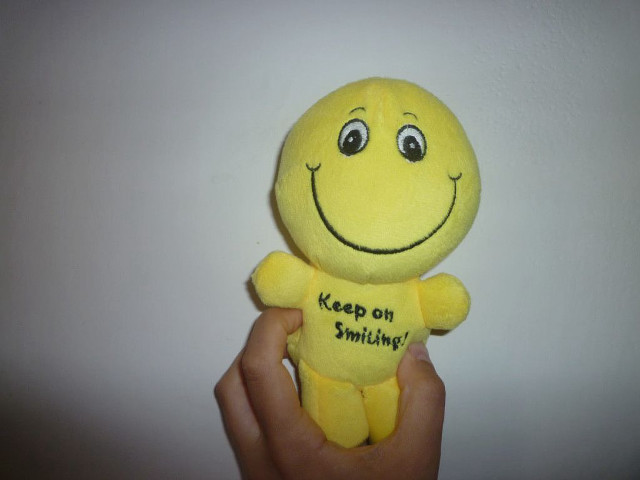 Yellow stuffed smiley face keep free wallpaper for desktop - medium preview image