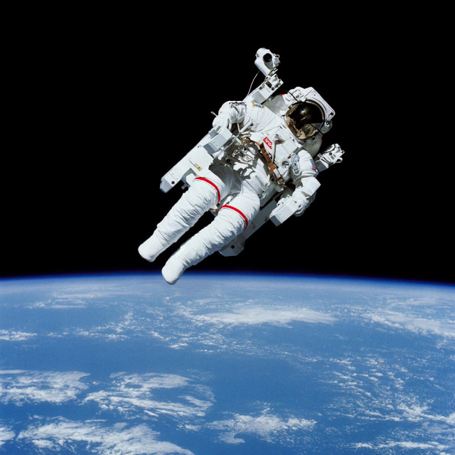 Astronaut floating above earth space free wallpaper for tablet - medium preview image
