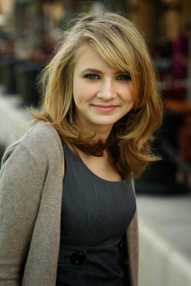 Smiling woman gray sweater black free wallpaper for mobile - medium preview image