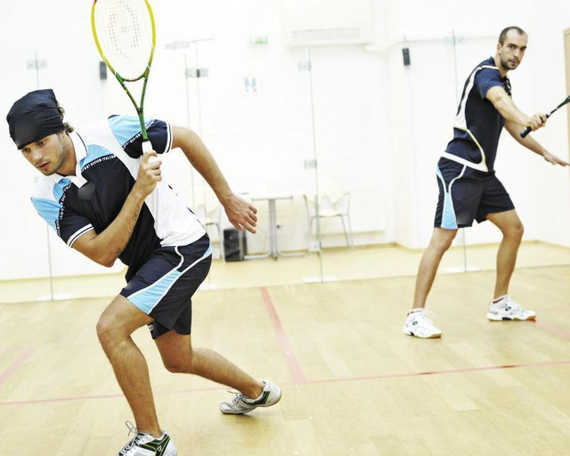 Man holding tennis racquet gym free wallpaper for desktop - medium preview image