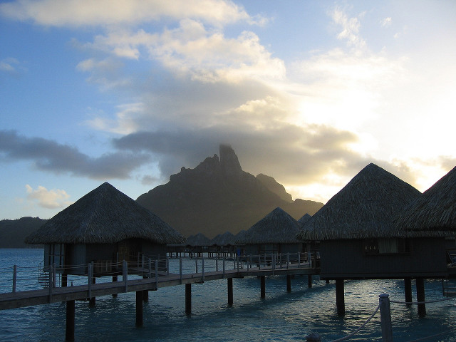 Pier thatched huts mountain clouds free wallpaper for desktop - medium preview image