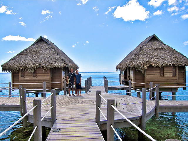 Couple people dock huts thatched free wallpaper for desktop - medium preview image