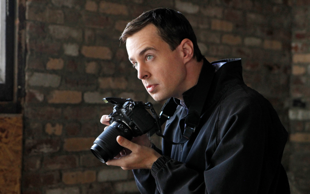 Man holding camera looking lens free wallpaper for desktop - medium preview image